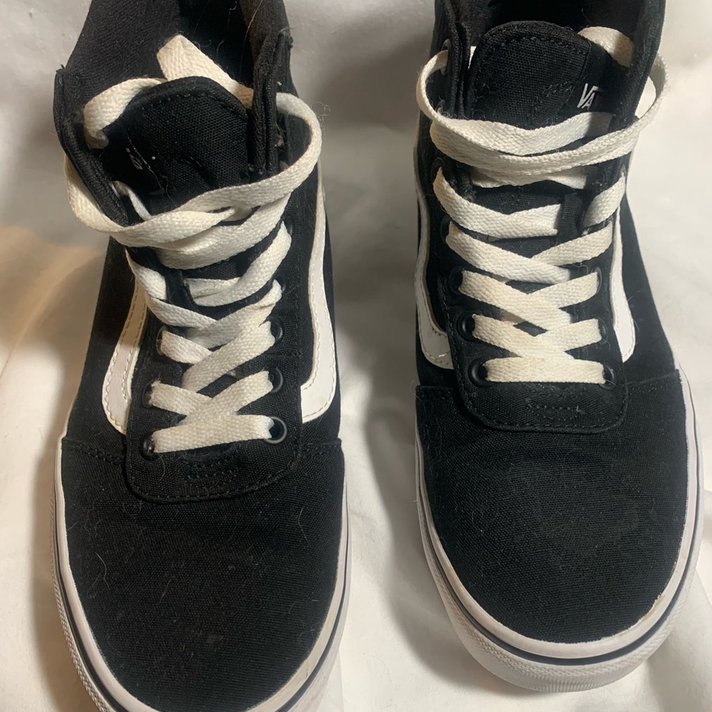 Vans women’s Black and White High-Top Sneakers